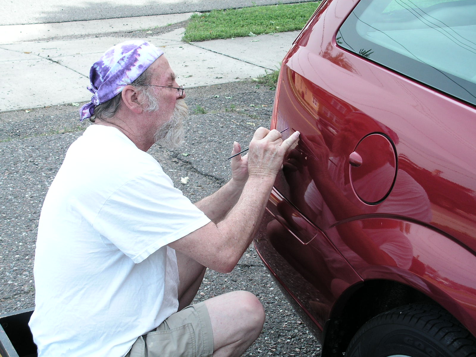 Ron Brockmeier painting a car